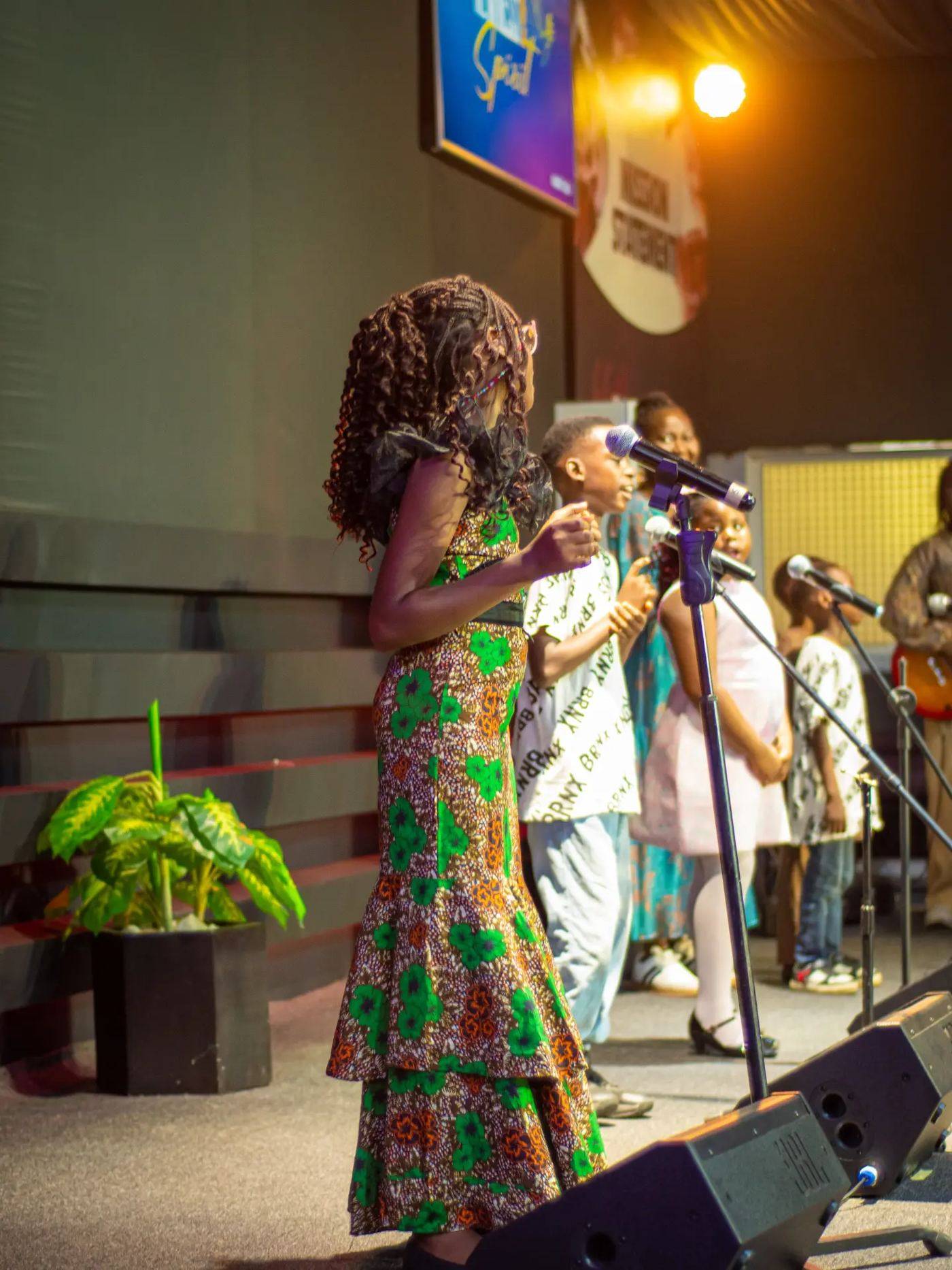Children singing on stage as part of Junior Church